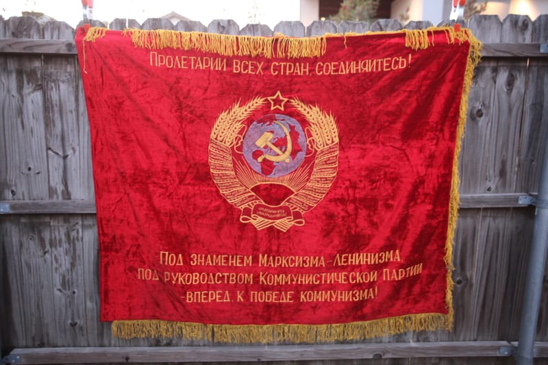 Soviet red velvet flag with hammer-and-sickle emblem and Marxism-Leninism slogan