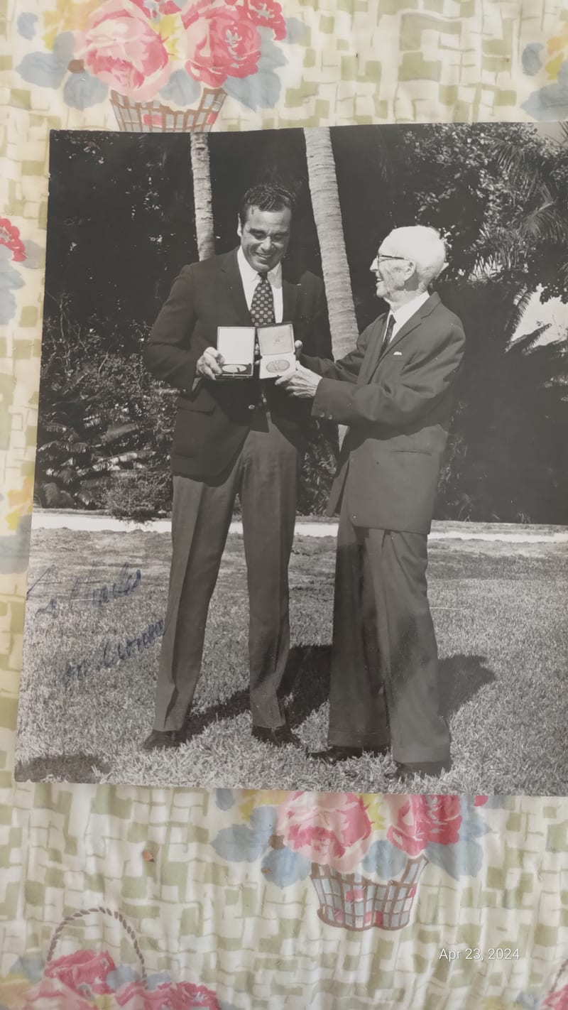 Press photograph of Donald Aronow receiving a medal